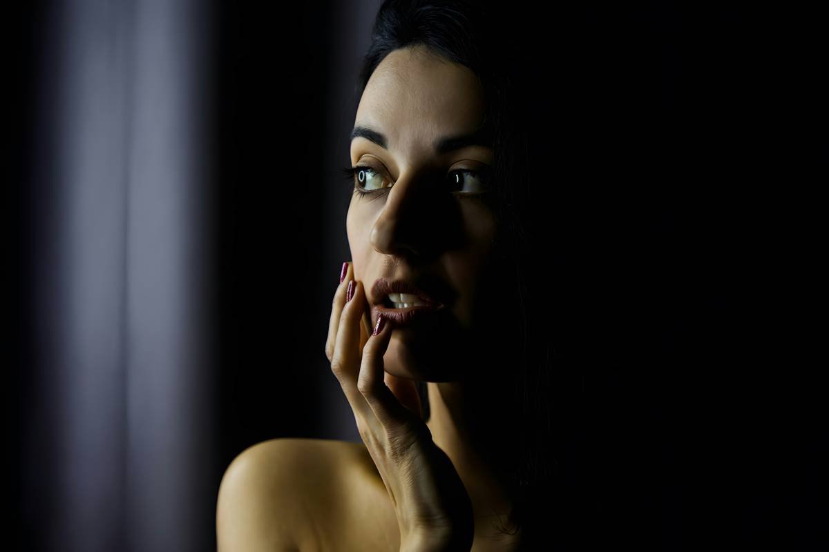 Model applying foundation with sponge for event makeup for photos