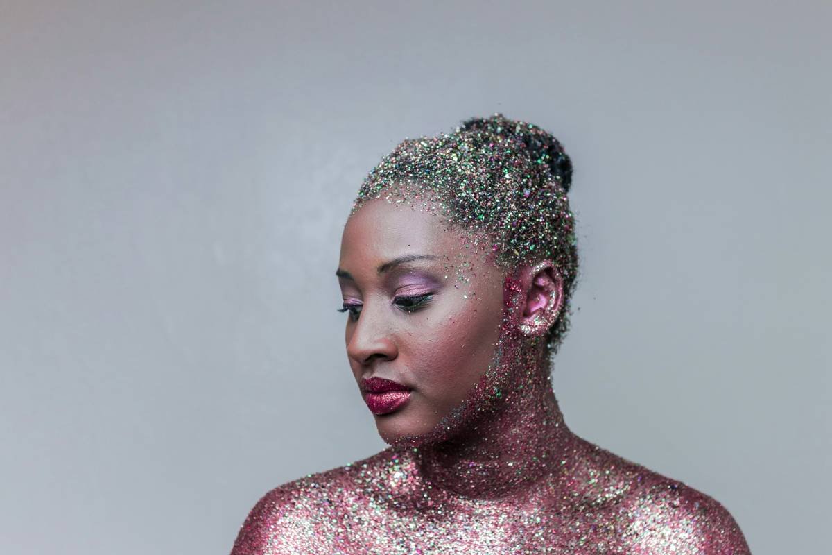 Festival season makeup applied on model with bold eyes and glowing skin at outdoor celebration