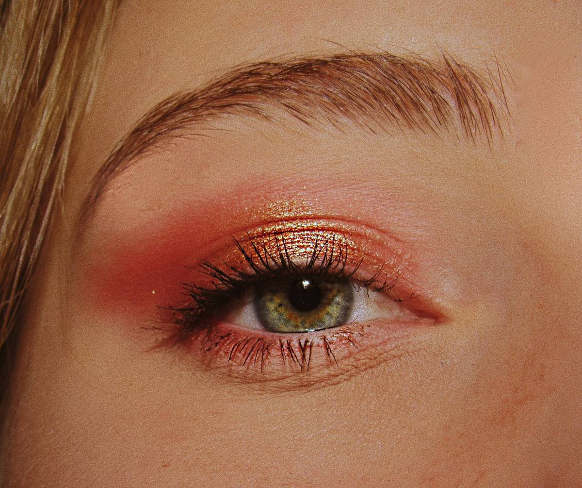 Model showcasing vibrant party eye shadow looks with shimmer and winged liner